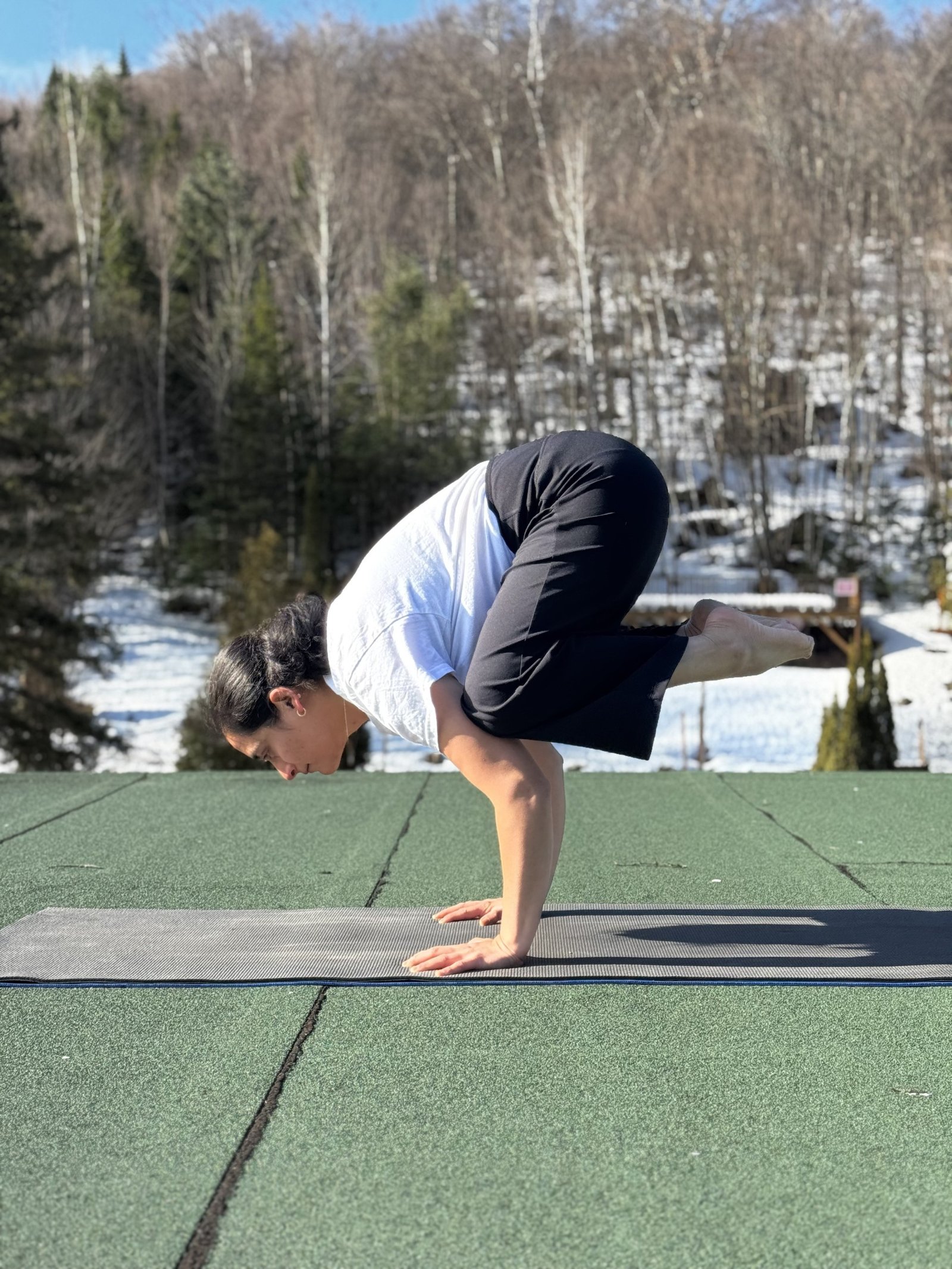 Purnima in crow pose outdoors