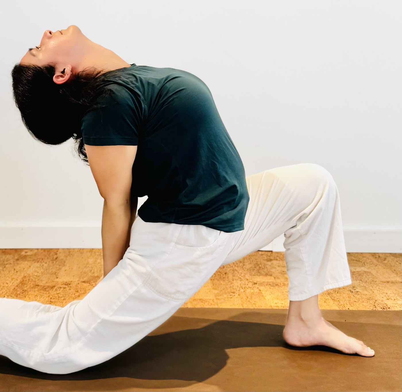 Purnima in a low lunge with a gentle backbend