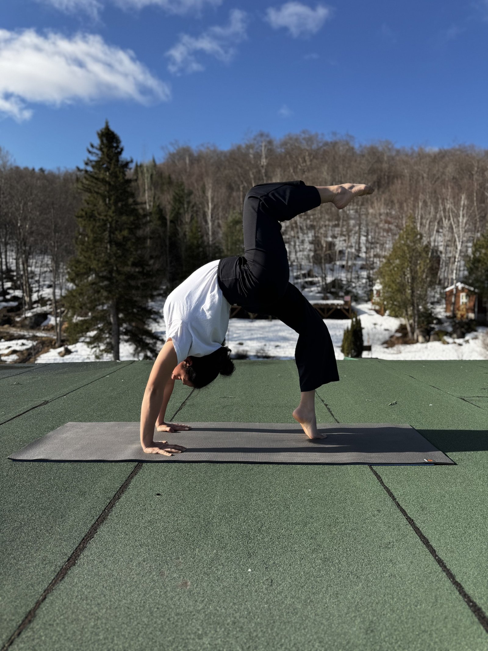 Purnima in a one-legged wheel pose outdoors